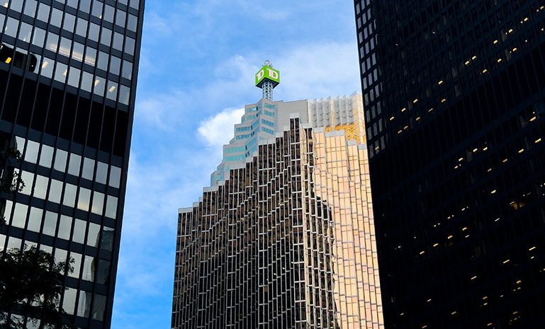 A TD Canada Trust sign seen atop, from street level on the TD Canada Trust Tower