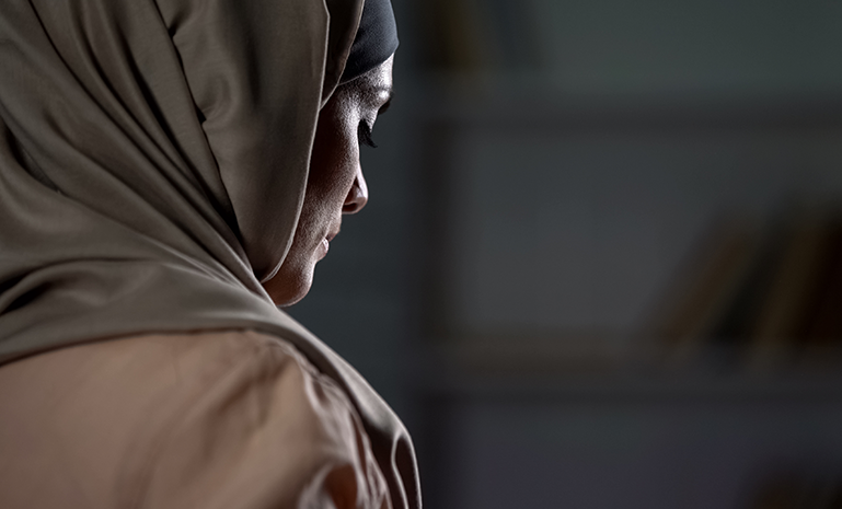Woman in headscarf looking down