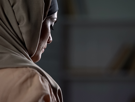 Woman in headscarf looking down