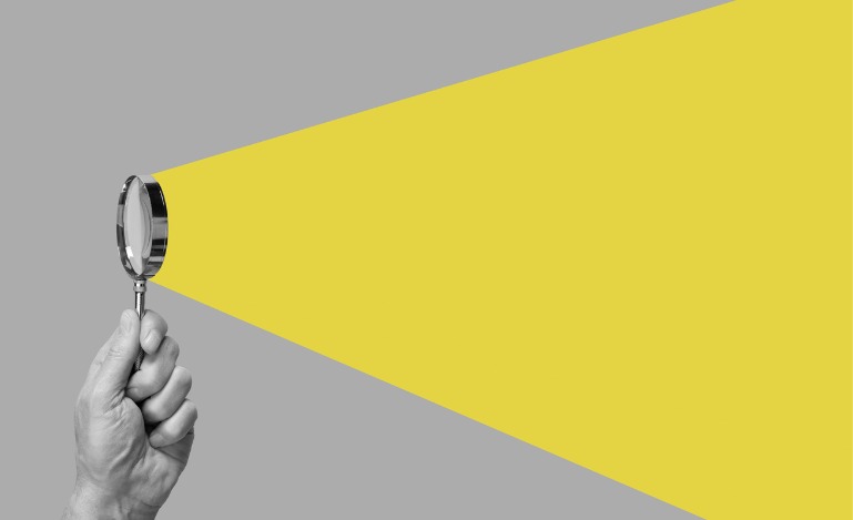 man-hand-with-magnifying-glass
