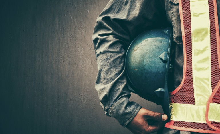 Worker holding helmet
