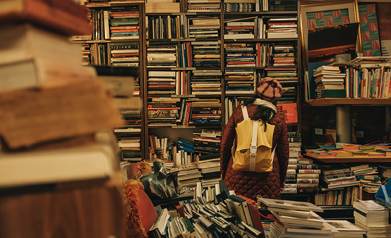 Woman looking in a messy bookshop