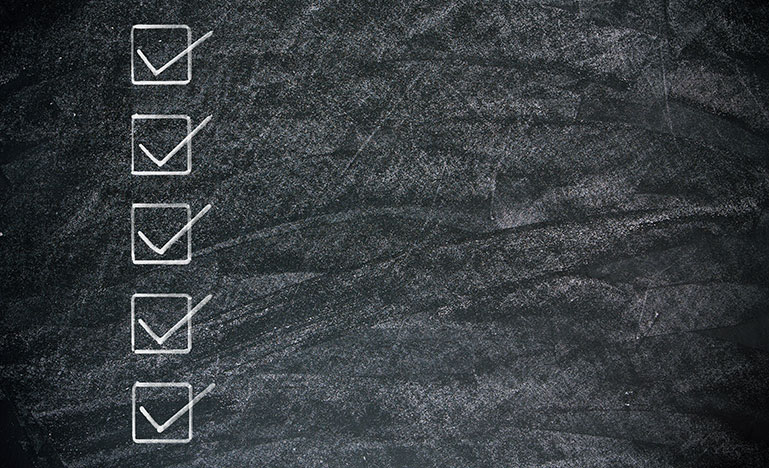 Checklist on blackboard background