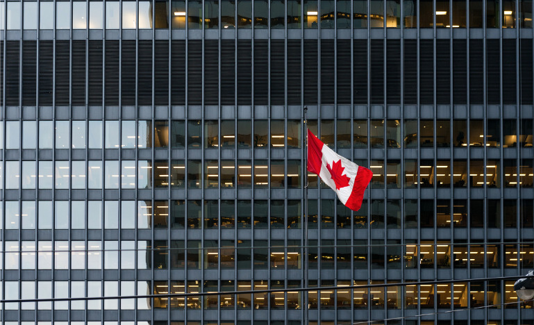 Canadian flag in front of office building