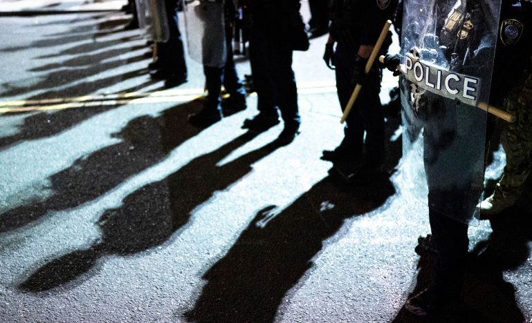 Line of police in riot gear