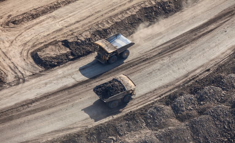 Dump trucks on a mining road near Fort McMurray
