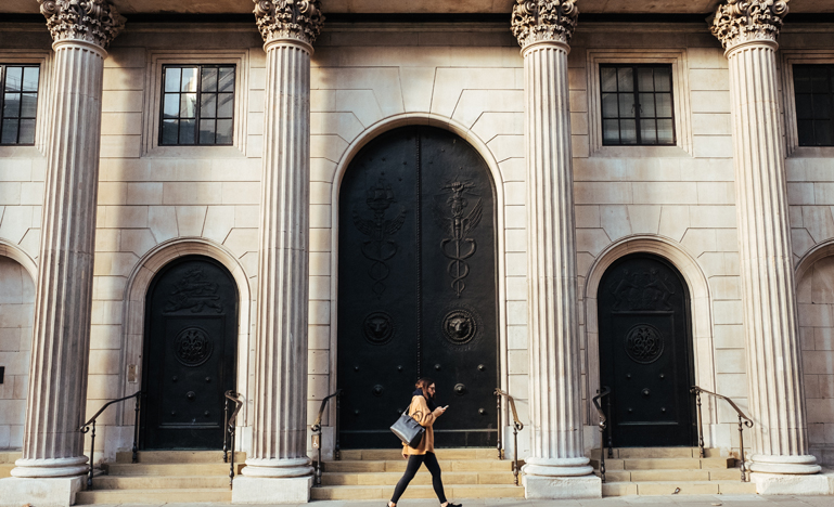 Woman walking in front of bank