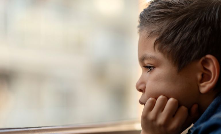 Child looking out a window