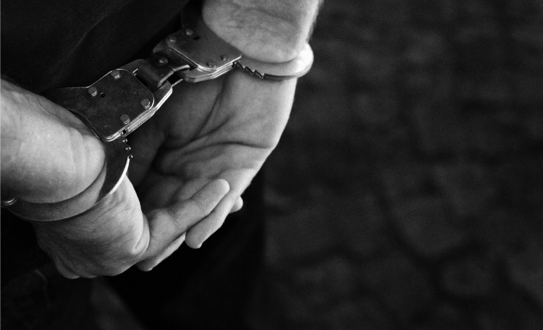 Man with handcuffs behind his back