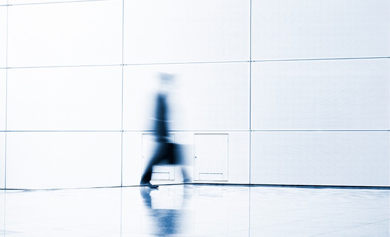Blurred businessman walking