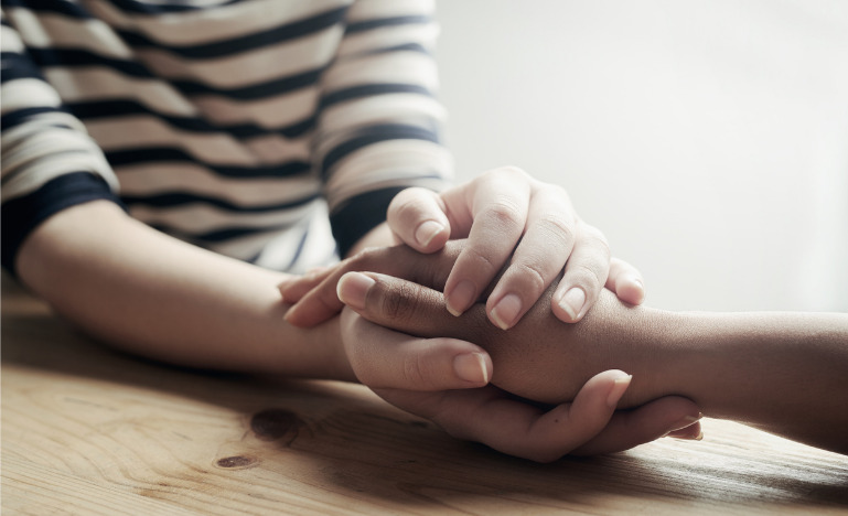 Woman comforting another