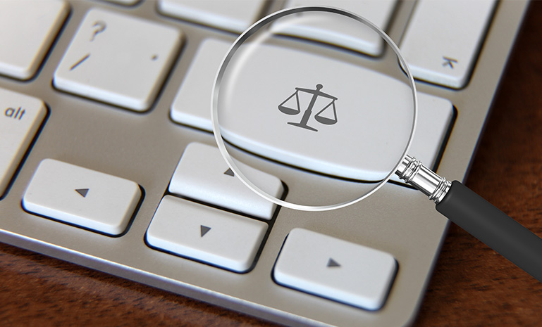 Magnifying glass on a justice scale keyboard key