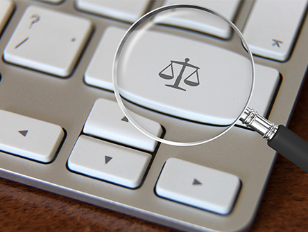Magnifying glass on a justice scale keyboard key