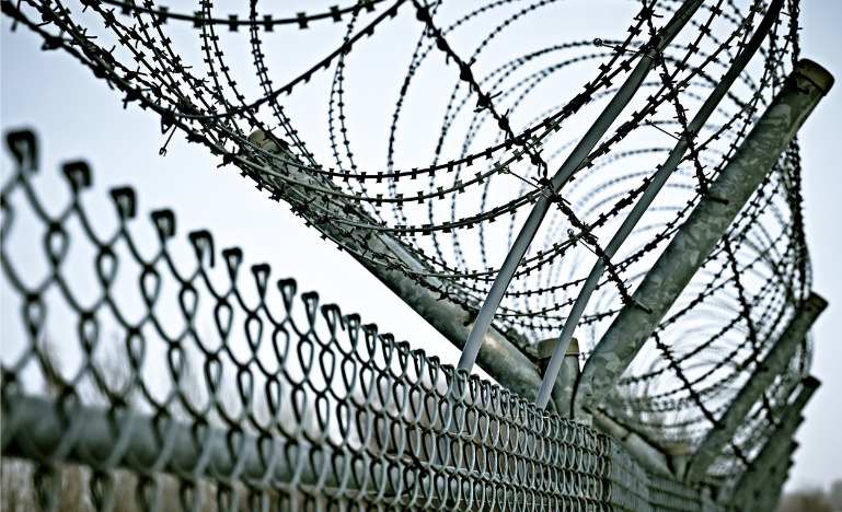 Fence with barbed wire