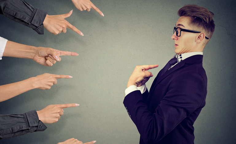 Anxious man judged by different people pointing fingers at him