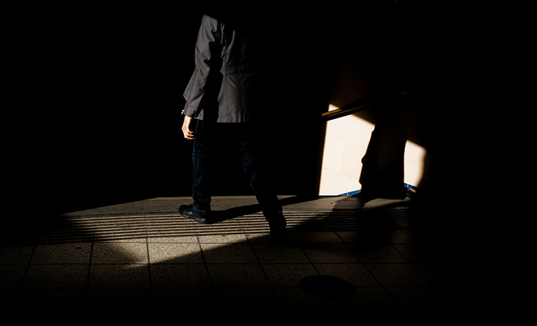 Image of a man in a suit walking