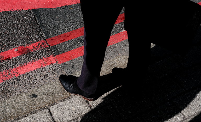 Man standing on pavement 