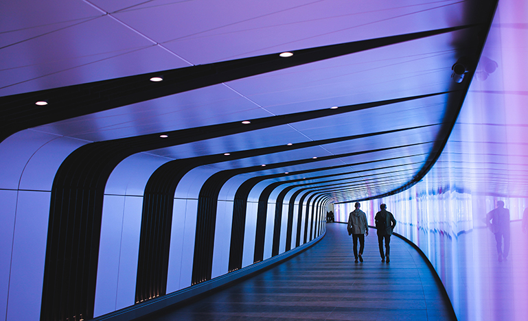 people walking in tunnel