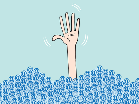 A hand drowning in a sea of emails