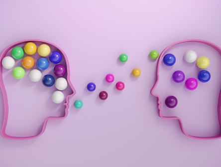 Human heads connected by multi-coloured spheres, symbolizing mentorship