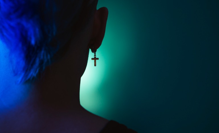 Woman with cross hanging from her ear