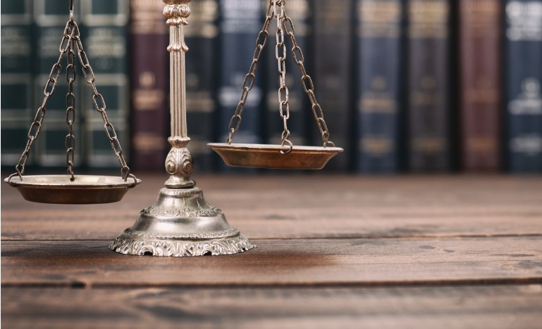 Scales of justice books in background
