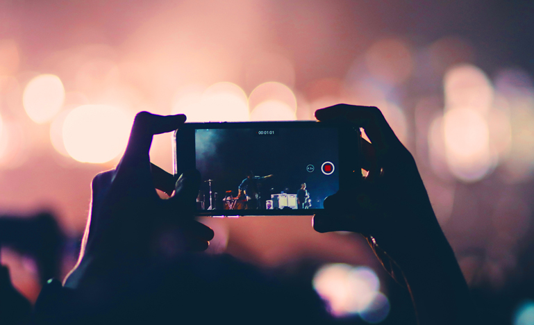 Someone holding phone up to take a video