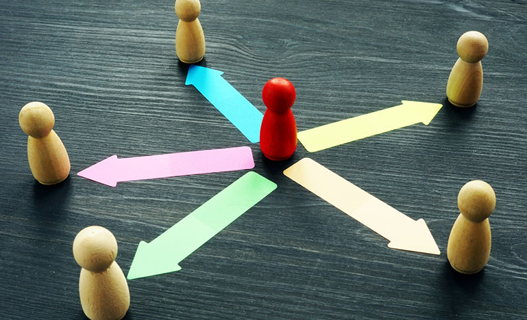 Delegating concept. Wooden figures and arrows