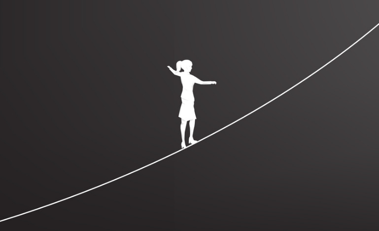 Silhouette of a woman on on a tightrope