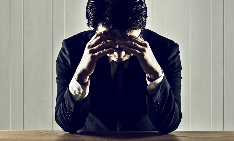 Businessman holding a head