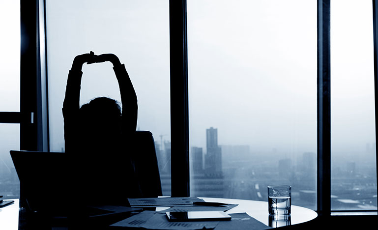 Person stretching in their office