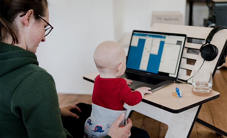 Mother with child looking at computer screen