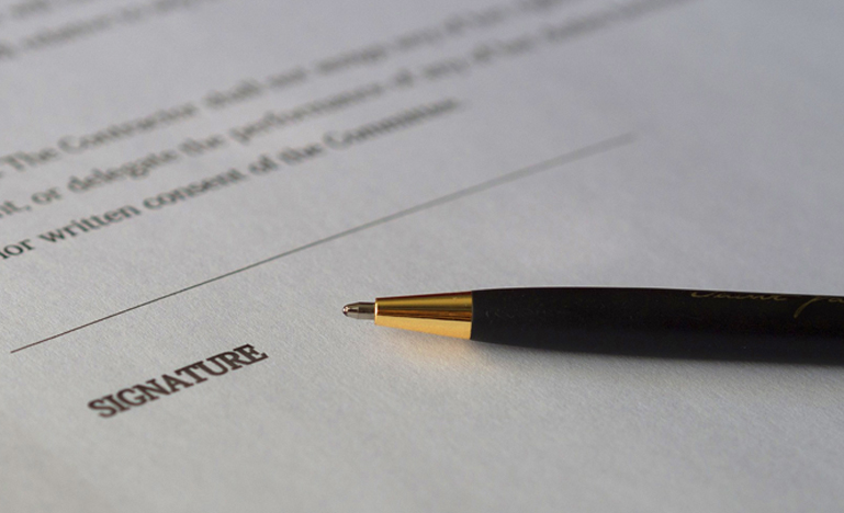 Pen over signature section of agreement 