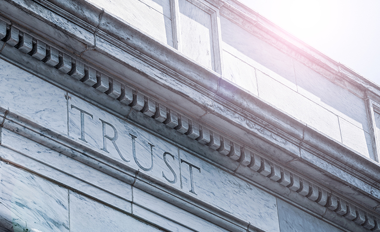 Trust word carved in a wall