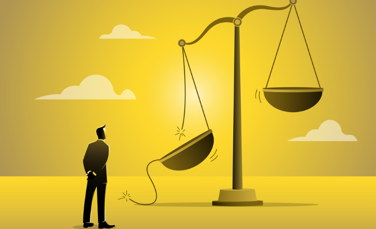 A man looks at a broken scale of justice
