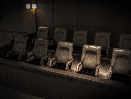 Empty chairs in a darkened jury box in a courtroom