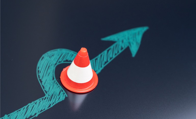 Chalk drawing arrow past cone