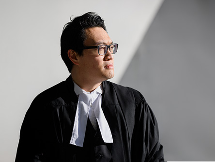 Will Tao in black lawyer robes
