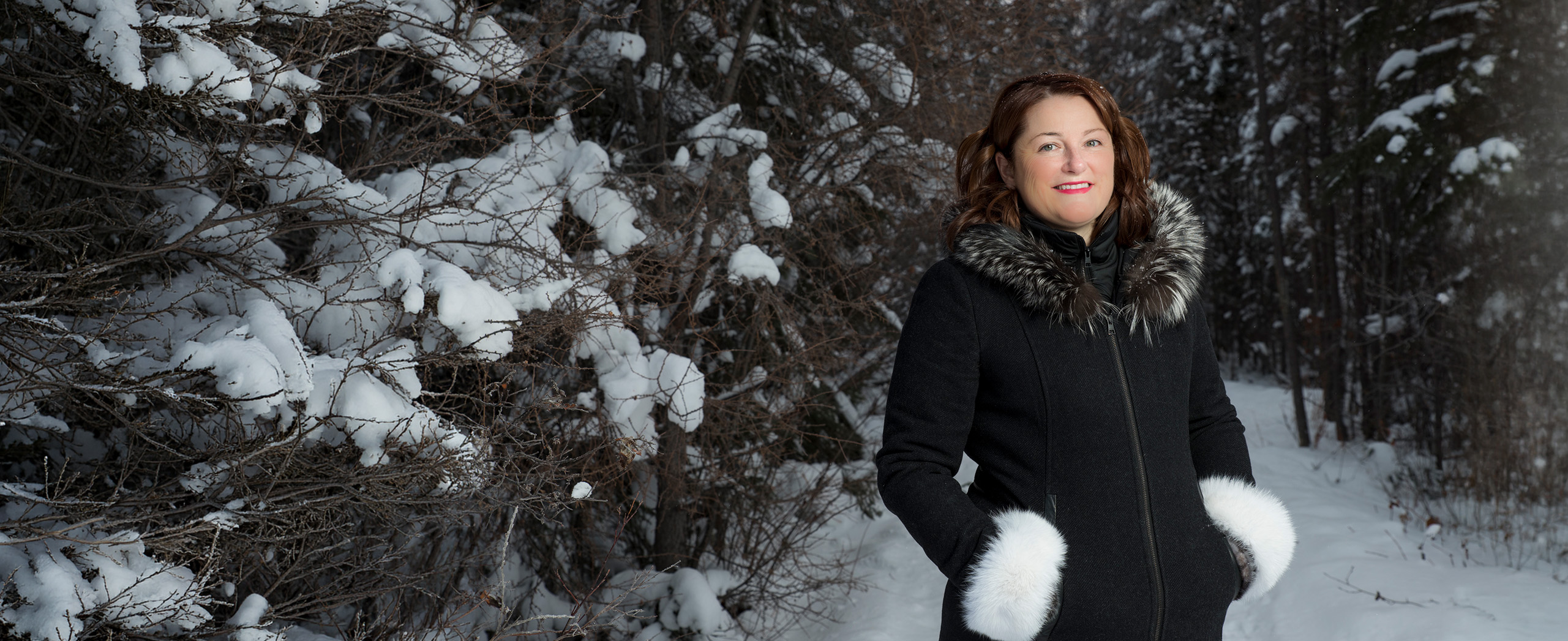 Sandra MacKenzie in the snowy woods near Yellowknife
