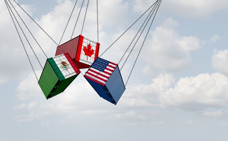 Three suspended shipping containers with the flags of Mexico, Canada and the United States