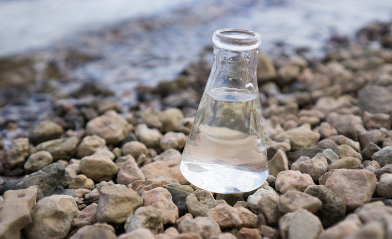 Chemical flask with river water in it for testing