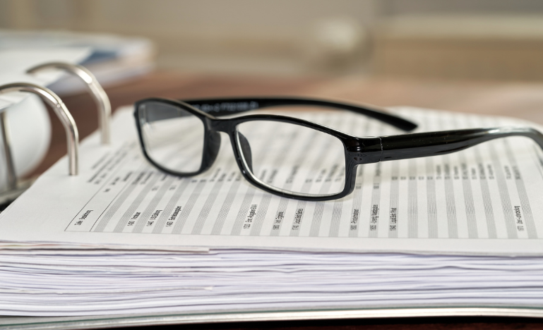 Glasses laying on a spreadsheet