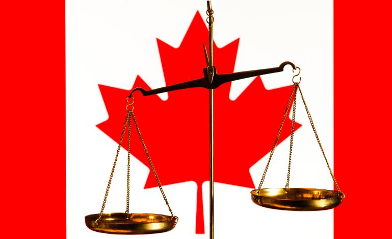 The scales of justice imposed over the Canadian flag