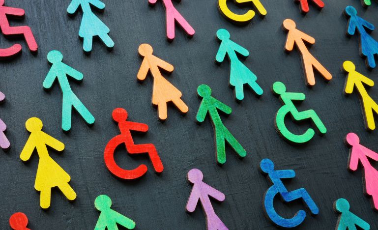 Colourful figurines on the dark surface. Diversity and inclusion concept.