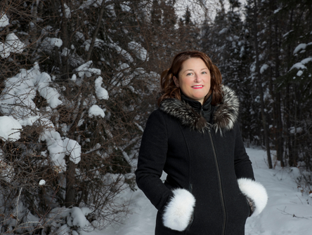 Sandra MacKenzie in the snowy woods near Yellowknife
