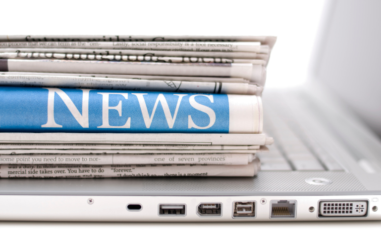 Canadian newspapers on a computer keyboard