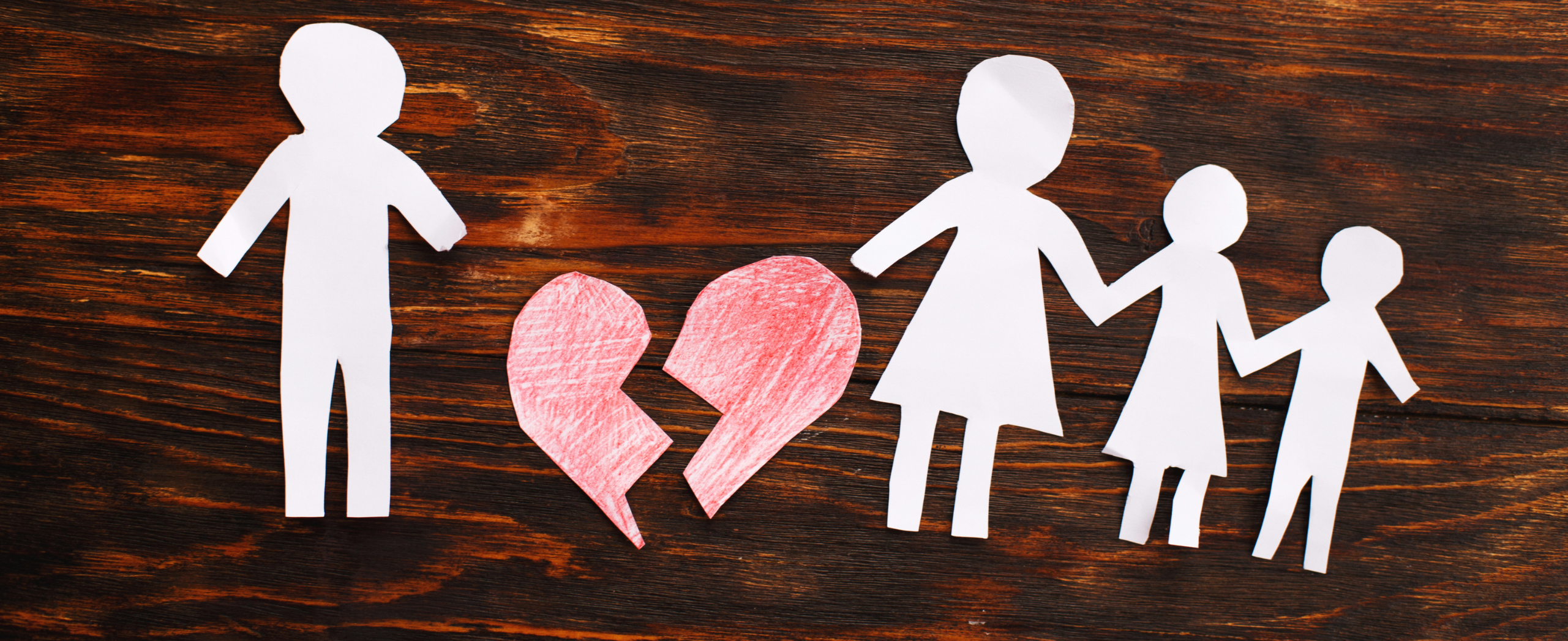 Paper chain cut family with broken heart on wooden background